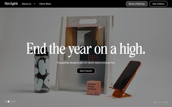 Merchgirls homepage with an oversized seasonal headline over a branded gift set.